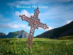 Cross in the ground with text written "Because He Lives"